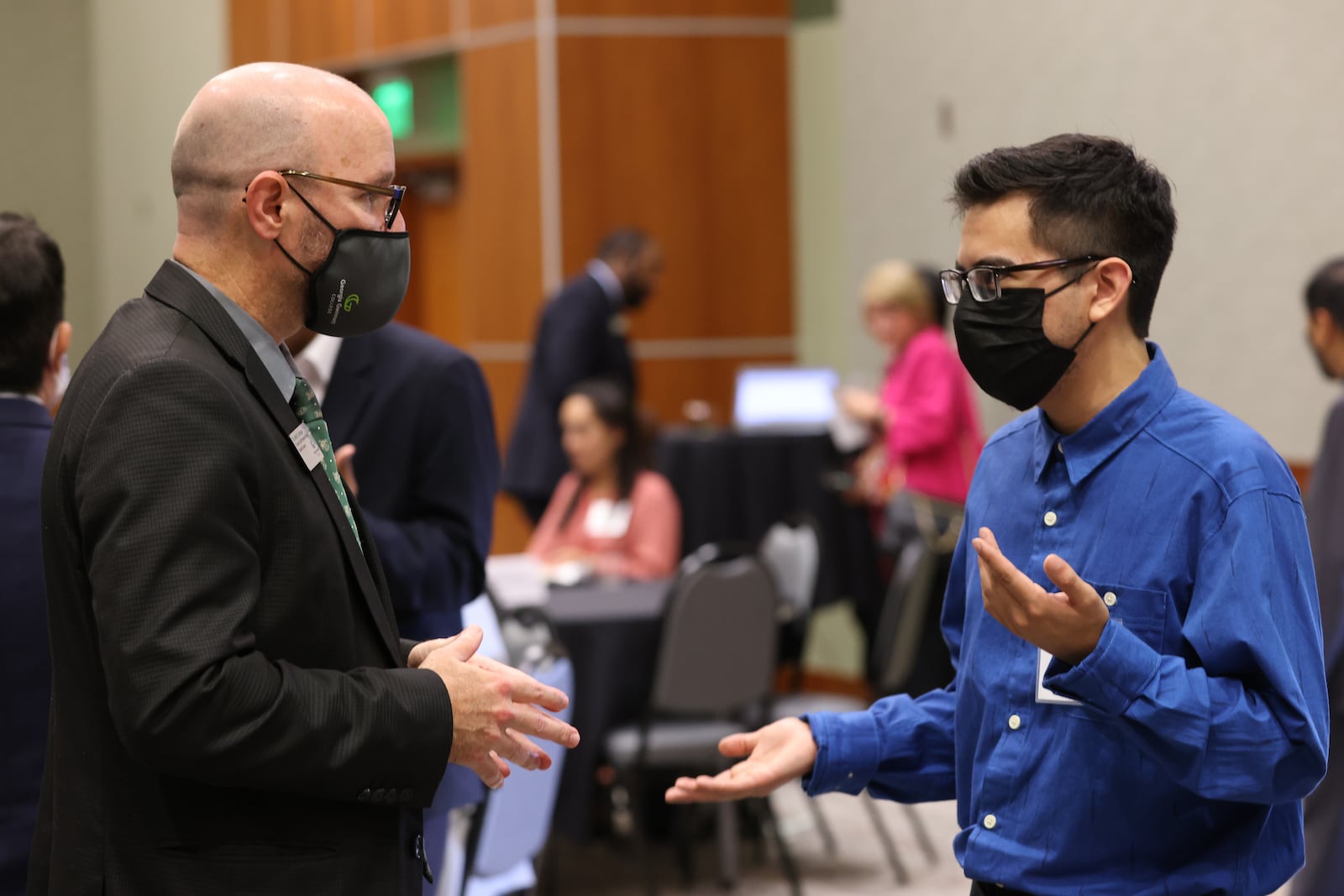 Georgia Gwinnett College student Brian Catalan (right) interacts with Justin Jernigan, its senior associate vice president and dean of student success, at a recent event. Catalan stated that he wanted to take advantage of the event to look for the career opportunity that is right for him. (Miguel Martinez for The Atlanta Journal-Constitution)