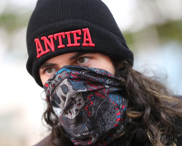 A masked antifa protester from a march in Atlanta following violence in Charlottesville, Va. CURTIS COMPTON / CCOMPTON@AJC.COM