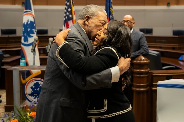 Fulton County Board of Commissioners Chair Robb Pitts embraces Commissioner Mo Ivory at her swearing in at the Fulton County Government Center Assembly Hall in Atlanta, Georgia on Friday, Jan. 3, 2025. (Olivia Bowdoin for the AJC). 