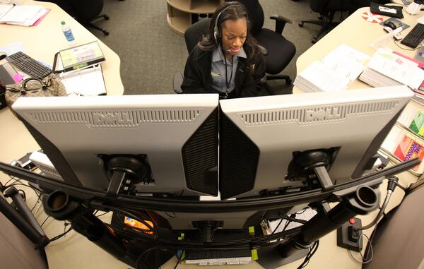 ChatCom dispatcher Shireka Graham has her eyes on five computer screens while taking calls at the Dunwoody call center Sept. 5, 2012. AJC FILE PHOTO