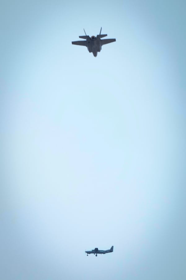 An Israeli fighter jet flies over a Lebanese airforce Cessna plane during the funeral ceremony of Hezbollah's former leader Hassan Nasrallah and his cousin and successor Hashem Safieddine in the Sports City Stadium in Beirut, Lebanon, Sunday, Feb. 23, 2025. (AP Photo/Hussein Malla)