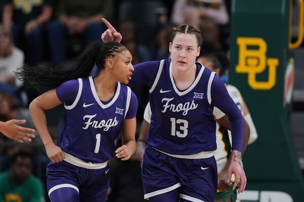 TCU's Sedona Prince (13) and Taylor Bigby (1) celebrate after a basket by Prince in the first half of an NCAA college basketball game against Baylor in Waco, Texas, Sunday, March 2, 2025. (AP Photo/Tony Gutierrez)