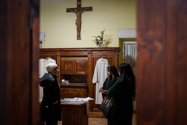 From left to right: Transgenders Camila Romero, Minerva, and Carla Segovia talk in the sacristy of the Beata Vergine Immacolata parish church in Torvaianica, Italy, Thursday, Feb. 27, 2025. (AP Photo/Bernat Armangue)