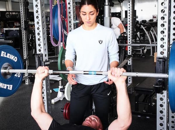 Kelsey Martinez, the first female coach in Raiders history, helps wide receiver Jordy Nelson on the bench press on April 9, 2018. (Oakland Raiders/TNS)