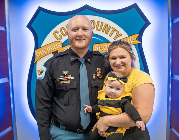 Cobb County Officer Aaron Wilson, with his wife Sarah and 6-month-old daughter Ella Grace.