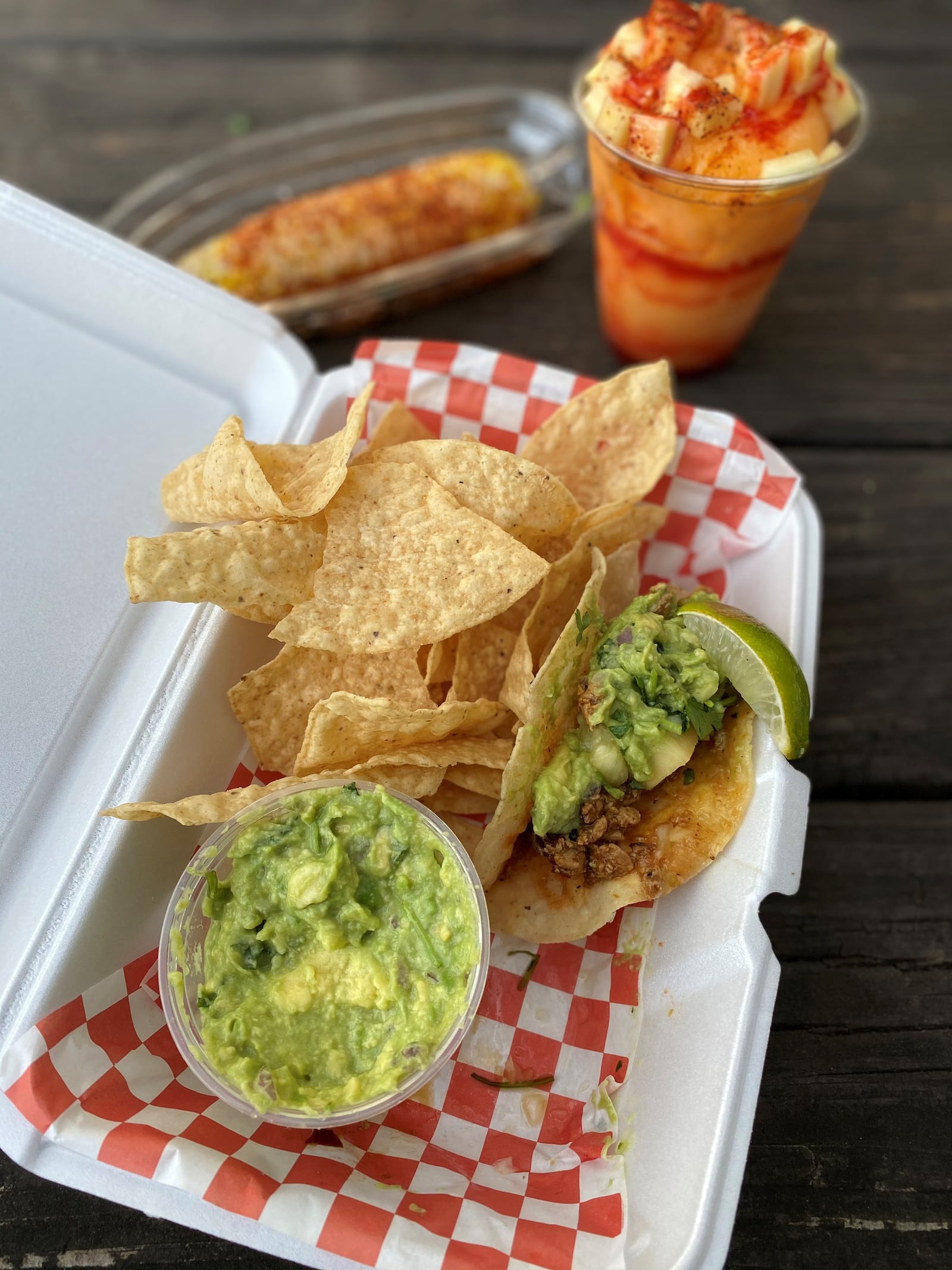 Among the offerings at Chi Chi Vegan Taco Shop are chips and guacamole with an al pastor taco in a crispy corn tortilla; Mexican corn on the cob; and a mango drink. Wendell Brock for The AJC