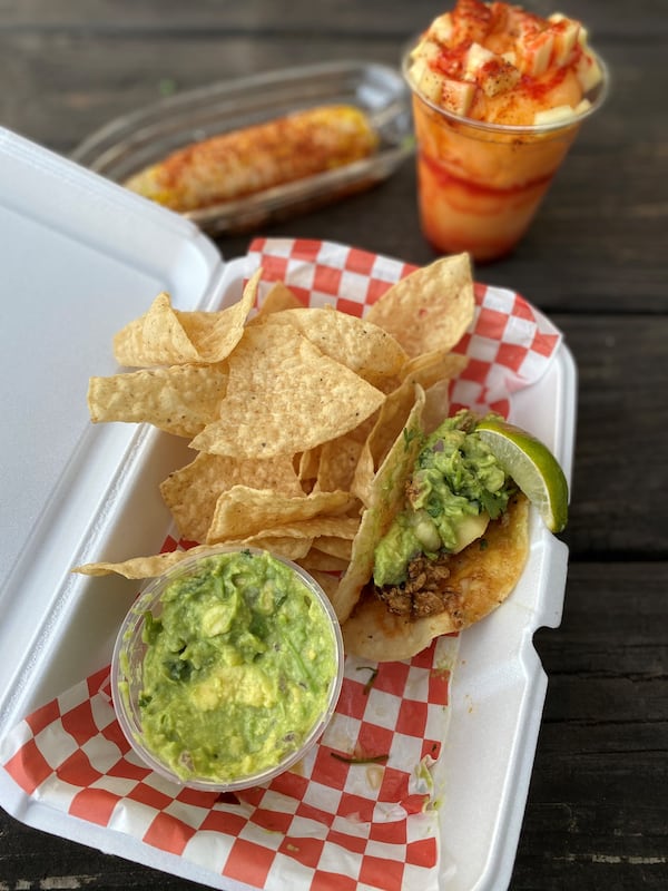 Among the offerings at Chi Chi Vegan Taco Shop are chips and guacamole with an al pastor taco in a crispy corn tortilla; Mexican corn on the cob; and a mango drink. Wendell Brock for The AJC