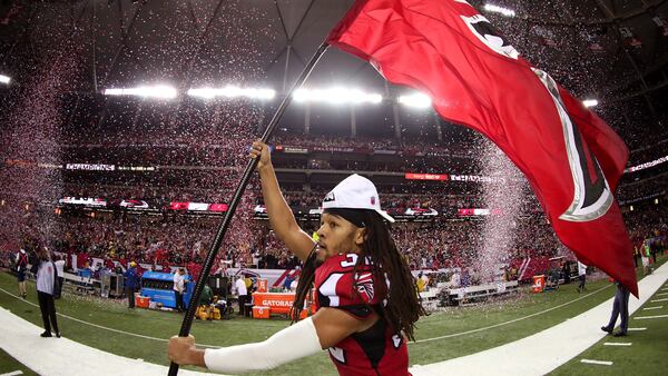  Jalen Collins runs through the field with a Falcons flag after defeating the Green Bay Packers in the NFC Championship Game at the Georgia Dome on January 22, 2017 in Atlanta, Georgia. The Falcons defeated the Packers 44-21. (Tom Pennington/Getty Images)