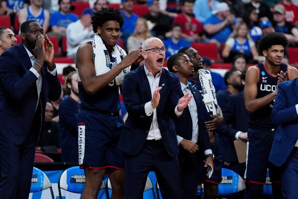 Connecticut head coach Dan Hurley, center, reacts during the first half in the second round of the NCAA college basketball tournament against Florida, Sunday, March 23, 2025, in Raleigh, N.C. (AP Photo/Stephanie Scarbrough)