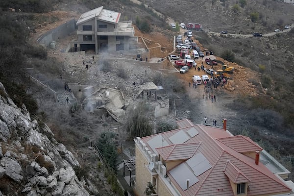 Rescue workers search for victims at a house hit in an Israeli airstrike in Baalchmay village east of Beirut, Lebanon, Tuesday, Nov. 12, 2024. (AP Photo/Hassan Ammar)