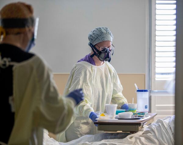 12/03/2020 —  Carrollton, Georgia —  Tanner Health System Hospital nurse Nicole Swanger prepares a lunch tray for a COVID-19 patient on the COVID-19 isolation floor at Tanner Health System Hospital in Carrollton Thursday, December 3, 2020. To try and curb staff to the exposure of COVID-19, nurses provide patients on the floor with their meals instead of the usual food service worker. (Alyssa Pointer / Alyssa.Pointer@ajc.com)