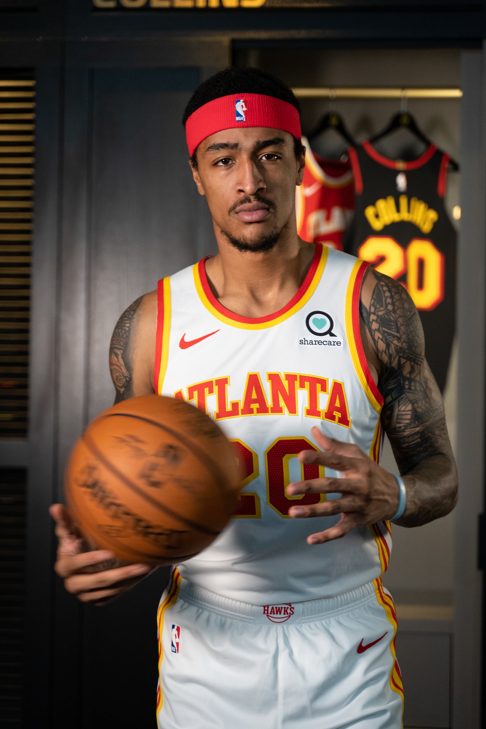 Hawks center John Collins models the new uniform whites for next season.