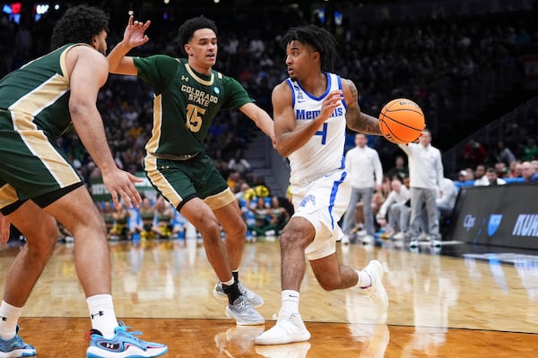 Memphis guard PJ Haggerty (4) drives against Colorado State guard Jalen Lake (15) during the second half in the first round of the NCAA college basketball tournament, Friday, March 21, 2025 in Seattle. (AP Photo/Lindsey Wasson)