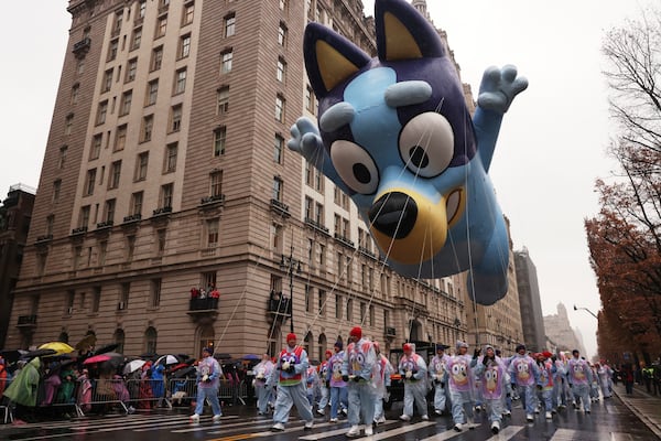 Handlers pull the Bluey balloon down Central Park West during the Macy's Thanksgiving Day Parade, Thursday, Nov. 28, 2024, in New York. (AP Photo/Yuki Iwamura)