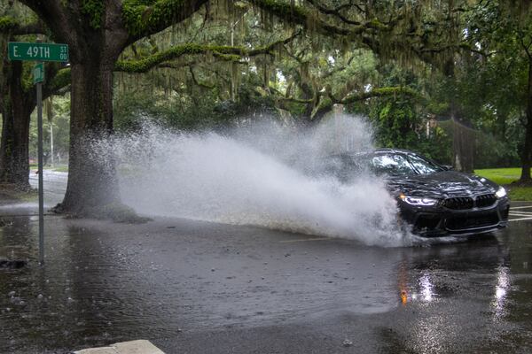 A car drives through a flooded street on Monday, August 5, 2024 in Savannah, GA. (AJC Photo/Katelyn Myrick)