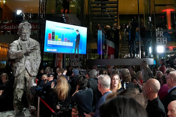 People react after first projections are announced during the election party at the Social Democratic Party (SPD) headquarters in Berlin, Germany, Sunday, March 23, 2025. (AP Photo/Ebrahim Noroozi)