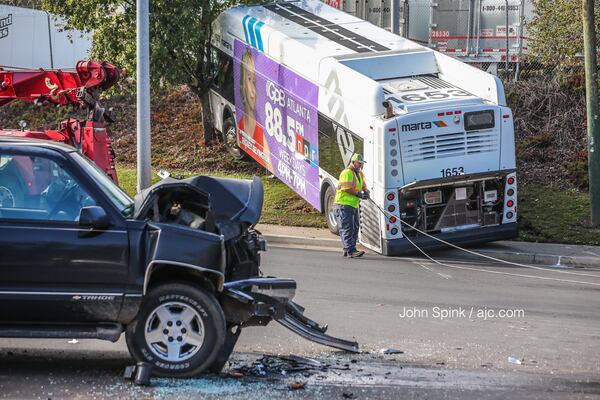 Authorities work to clean up a wreck involving an SUV and a MARTA bus on Donald E. Hollowell Parkway on Wednesday morning. JOHN SPINK / JSPINK@AJC.COM