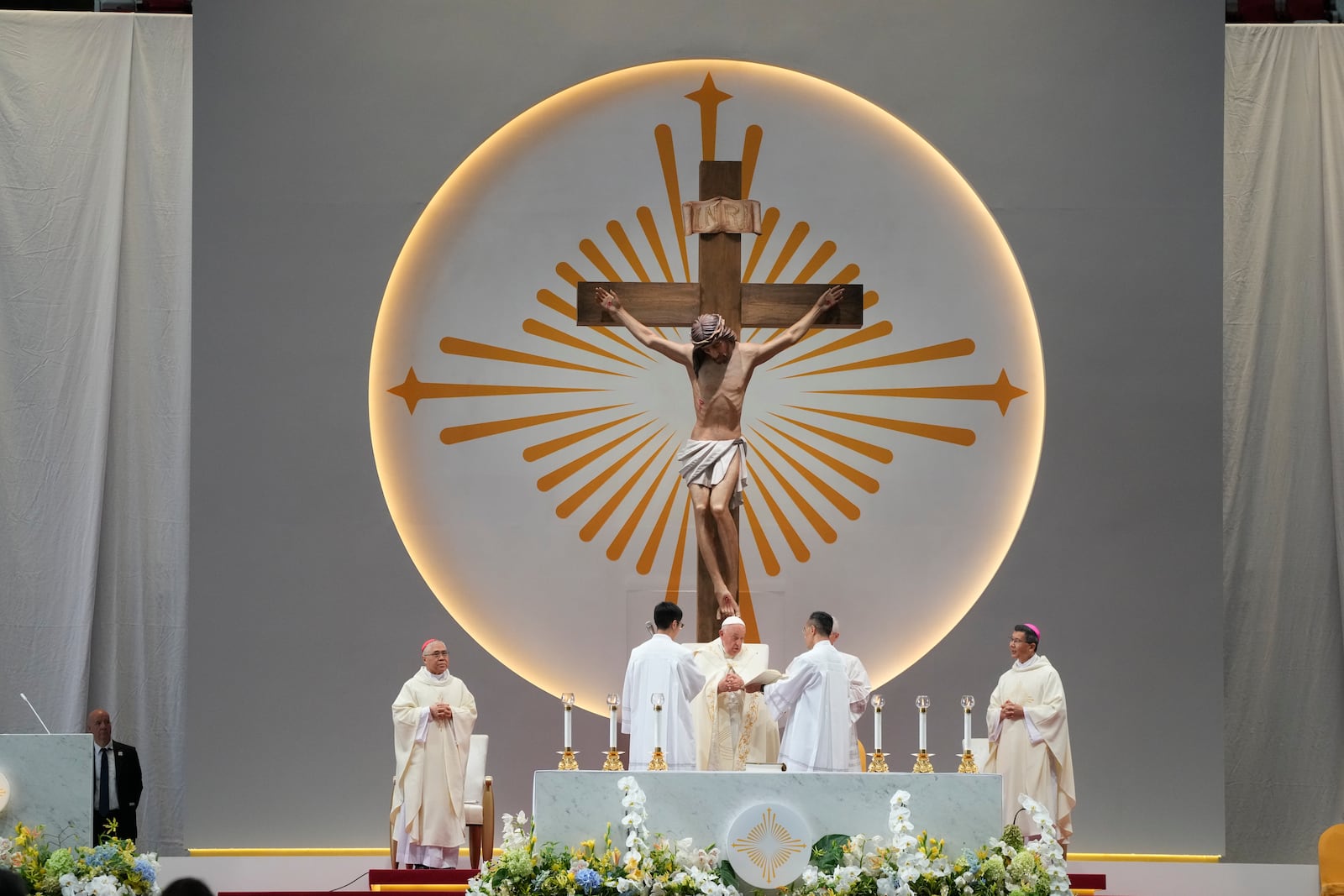 Pope Francis presides over a mass 'In Memory of the Most Holy Name of Mary' celebrated by the Archbishop of Singapore, Cardinal William Goh Seng Chye at the Singapore SportsHub National Stadium, Thursday, Sept. 12, 2024. Pope Francis has praised Singapore's economic development as a testament to human ingenuity. But he's urging the city-state to look after the weakest too. Francis made the remarks Thursday on the final leg of the longest and farthest tour of his papacy. (AP Photo/Gregorio Borgia)