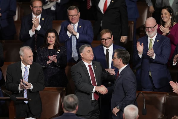 U.S. Rep. Andrew Clyde, a Republican from Athens, shakes hands with U.S. Rep. Mike Johnson after Johnson was reelected as House Speaker last week.