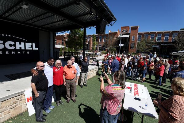 Republican U.S. Senate candidate Herschel Walker hobnobs with supporters during a campaign event in Canton. (Jason Getz / Jason.Getz@ajc.com)