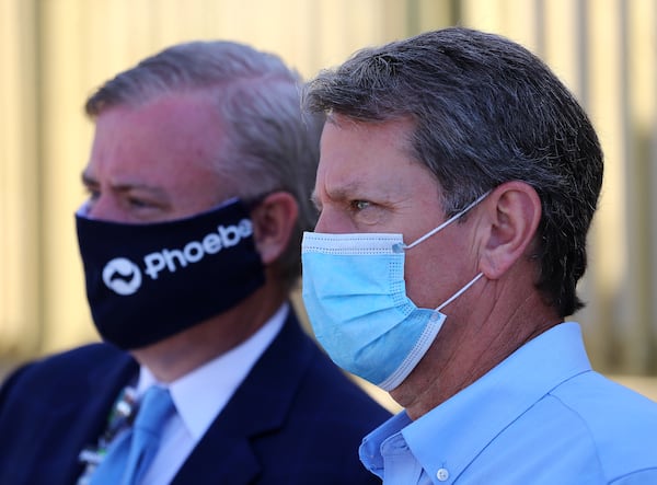 Gov. Brian Kemp (right) wears a mask while touring the temporary medical pod that has been placed at the Phoebe North Campus of Phoebe Putney Health System with their CEO Scott Steiner on Tuesday, May 5, 2020, in Albany. (Curtis Compton / AJC file photo)