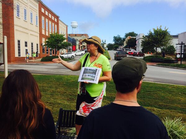 Tour guide Christina Tracy walks fans through the streets of Senoia, a primary location for the hit AMC TV series “The Walking Dead.” Photo credit: Jon Waterhouse