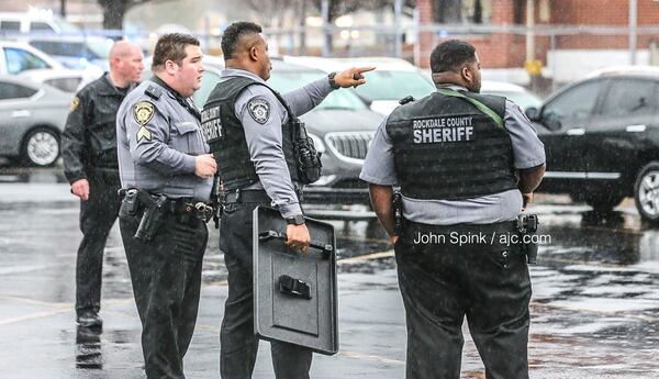 Rockdale County sheriff's deputies stand outside the Dart Container Corp. facility in Conyers where an employee was shot Friday morning. 