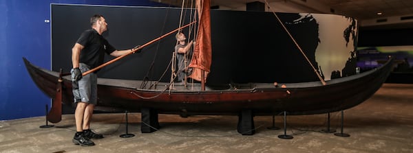 Members of MuseumsPartner Manfred Wittman (left) and Trent Rucker (right) put the finishing touches on a full-size replica of a Viking ship at Fernbank Museum of Natural History for "Vikings: Warriors of the Sea." (John Spink / John.Spink@ajc.com) 

