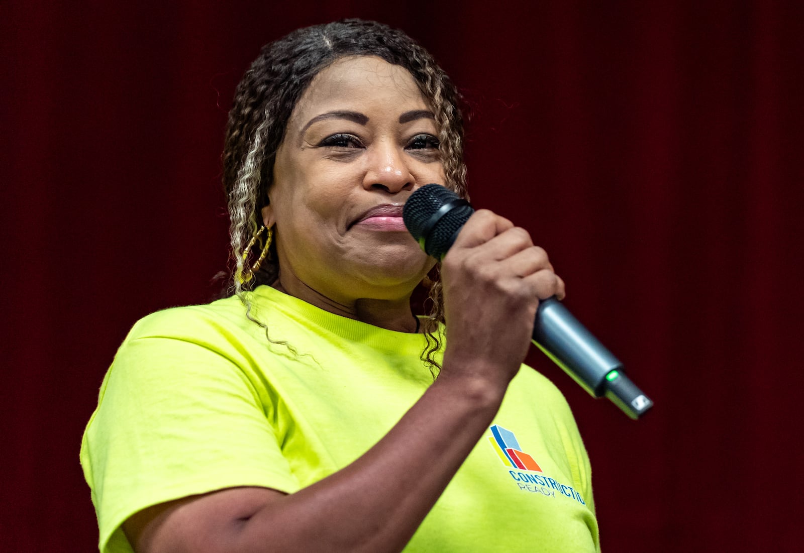 Kimberly Jones, a graduate of the Construction Ready training program, tears up while speaking at her graduation ceremony at the East Point City Hall Annex in East Point, GA on Friday, August 2, 2024. (Seeger Gray / AJC)