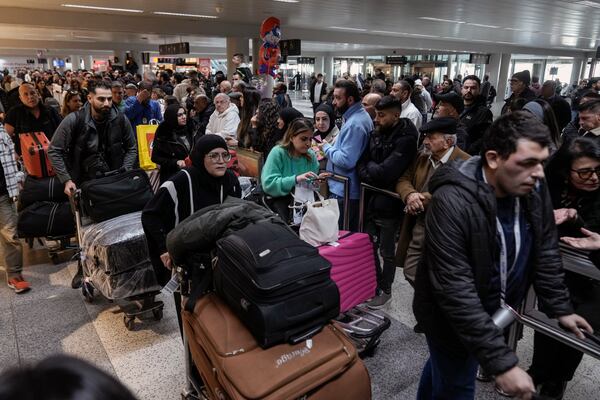 Travelers push their luggage as they arrive at the Rafik Hariri International Airport, in Beirut, Lebanon, Friday, Feb. 21, 2025. (AP Photo/Bilal Hussein)