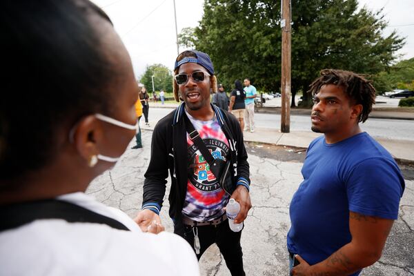 Residents of Mechanicsville, including Kenny Redding (center) and Terence Denson (right), gathered Aug. 9 for a rally. 