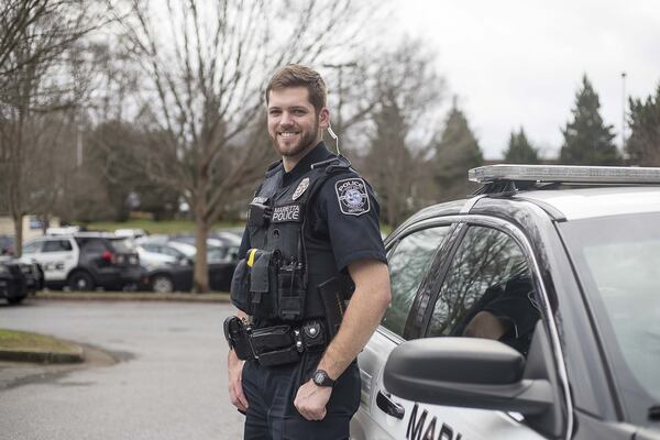 01/15/2019 — Marietta, Georgia — Marietta Police Officer Connor McDonald poses for a photo near his patrol car at the Marietta Police Department, Wednesday, January 15, 2020. (ALYSSA POINTER/ALYSSA.POINTER@AJC.COM)