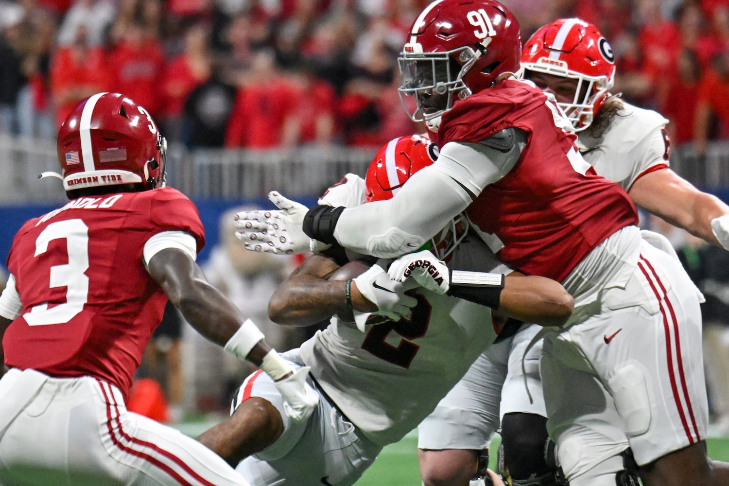 Alabama Crimson Tide defensive lineman Jaheim Oatis (91) tries to stop Georgia Bulldogs running back Kendall Milton (2) during the first half of the SEC Championship football game at the Mercedes-Benz Stadium in Atlanta, on Saturday, December 2, 2023. (Hyosub Shin / Hyosub.Shin@ajc.com)