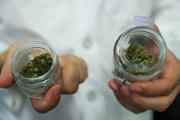 Charles Wu of Prescribd, a cannabis cultivation company, displays two containers of cannabis flowers that include different levels of delta-8 THC, a cannabis compound, during a tour at one of its cultivation centers in Bridgeview, Illinois. The interactive tour shows the start-to-finish process of growing cannabis. (John J. Kim
/Chicago Tribune/TNS)