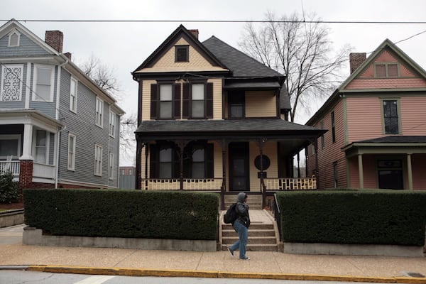 090111 ATLANTA - A passerby walks past the boyhood home (center) of the Rev. Dr. Martin Luther King Jr.  JESSICA MCGOWAN / jmcgowan@ajc.com