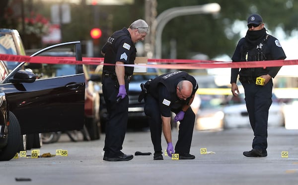 Chicago police investigate the scene of a shooting that killed rapper Carlton Weekly, known as FBG Duck. Charged with committing murder in aid of racketeering, assault in the aid of racketeering and various weapons charges are Chicago residents Charles Liggins, 30, Kenneth Roberson, 28, Tacarlos Offerd, 30, Christopher Thomas, 22, and Marcus Smart, 22. (Chris Sweda/Chicago Tribune/TNS)