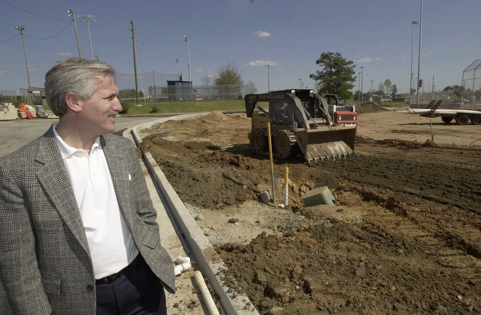 Dean Alford watches as a construction worker operates a skip-loader while spreading dirt at a baseball field in Conyers in 2000. Alford started the Miracle League, a baseball field specifically designed for children with disabilities, especially those in wheelchairs. 