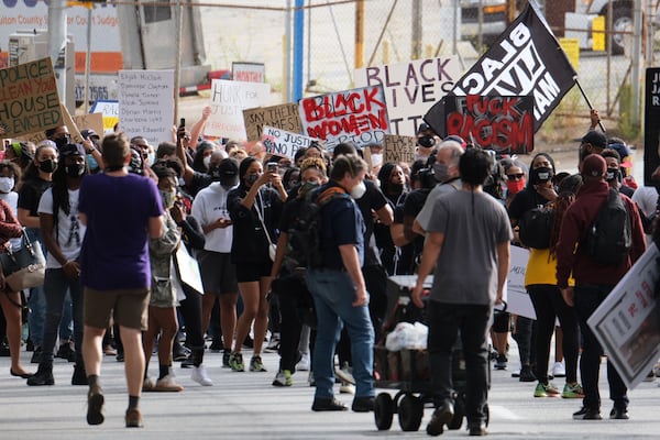 Protesters rally Friday in Atlanta, two days after the indictment in the Breonna Taylor case.