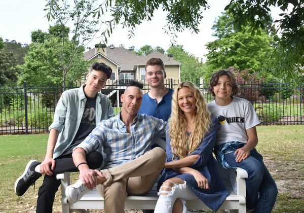 After moving to metro Atlanta from the Los Angeles area, filmmakers Jason and Heather DeVan, with their sons (background from left) Tristan, 16, P.K., 18, and Cassius, 12, have fielded lots of phone calls from friends on the West Coast interested in moving to the metro area. HYOSUB SHIN / HSHIN@AJC.COM