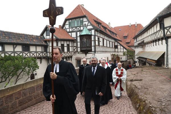 Protestant clergy, led by pastor Christian Mueller, walk in a procession with a cross to an open-air church service at Wartburg Castle to commemorate the May 4, 1521, arrival of Martin Luther on May 4, 2017 in Eisenach, Germany. Luther, who is known for his 95 theses of 1517 that set the Reformation into motion, lived at Wartburg Castle under protection following his excommunication and translated the Bible there into German. Germany is celebrating the 500th anniversary of the Reformation this year with events throughout the year. The Reformation led to the creation of Protestant denominations all over the globe.  (Photo by Sean Gallup/Getty Images)