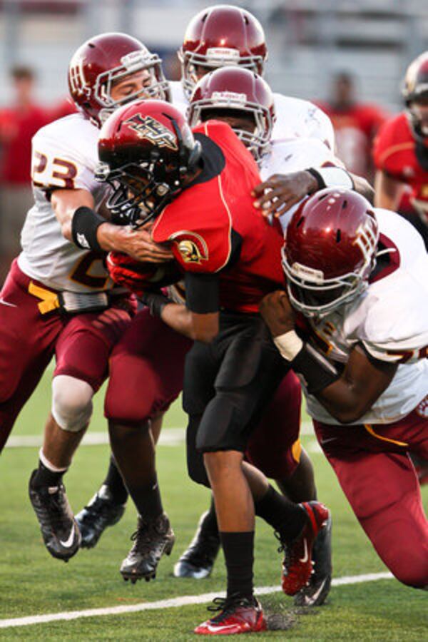 Greater Atlanta Christian's Kalif Raymond fights off four Holy Innocents defenders for a small gain.