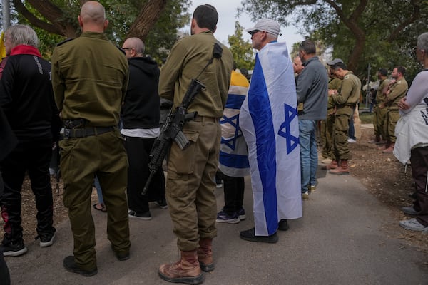 Mourners attend the funeral of Itzhak Elgarat, a slain hostage who was held captive by Hamas in Gaza, in Kibbutz Nir Oz, Israel, on Monday, March 3, 2025. (AP Photo/Ohad Zwigenberg)