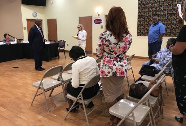 State Sen. Emanuel Jones, D-Lithonia (standing at left) listens to public comment from Mary Hinkel (center, in white) during the first of four town hall meetings scheduled by the DeKalb County Delegation to discuss the ethics referendums. After referendum opponents like Hinkel packed out the first two meetings, the final two were cancelled. (TIA MITCHELL/TIA.MITCHELL@AJC.COM)