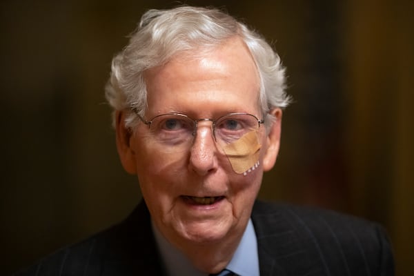 Senate Minority Leader Mitch McConnell of Ky. wears a bandage on his face as he walks to cast a vote on the Senate floor after falling during a luncheon on Capitol Hill, Tuesday, Dec. 10, 2024, in Washington. (AP Photo/Mark Schiefelbein)