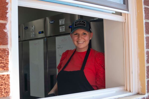 Ashley Hubbard, seen in the kitchen window, is owner of Tucker Brewing. Courtesy of Eliana Barnard, Tucker Brewing Co.