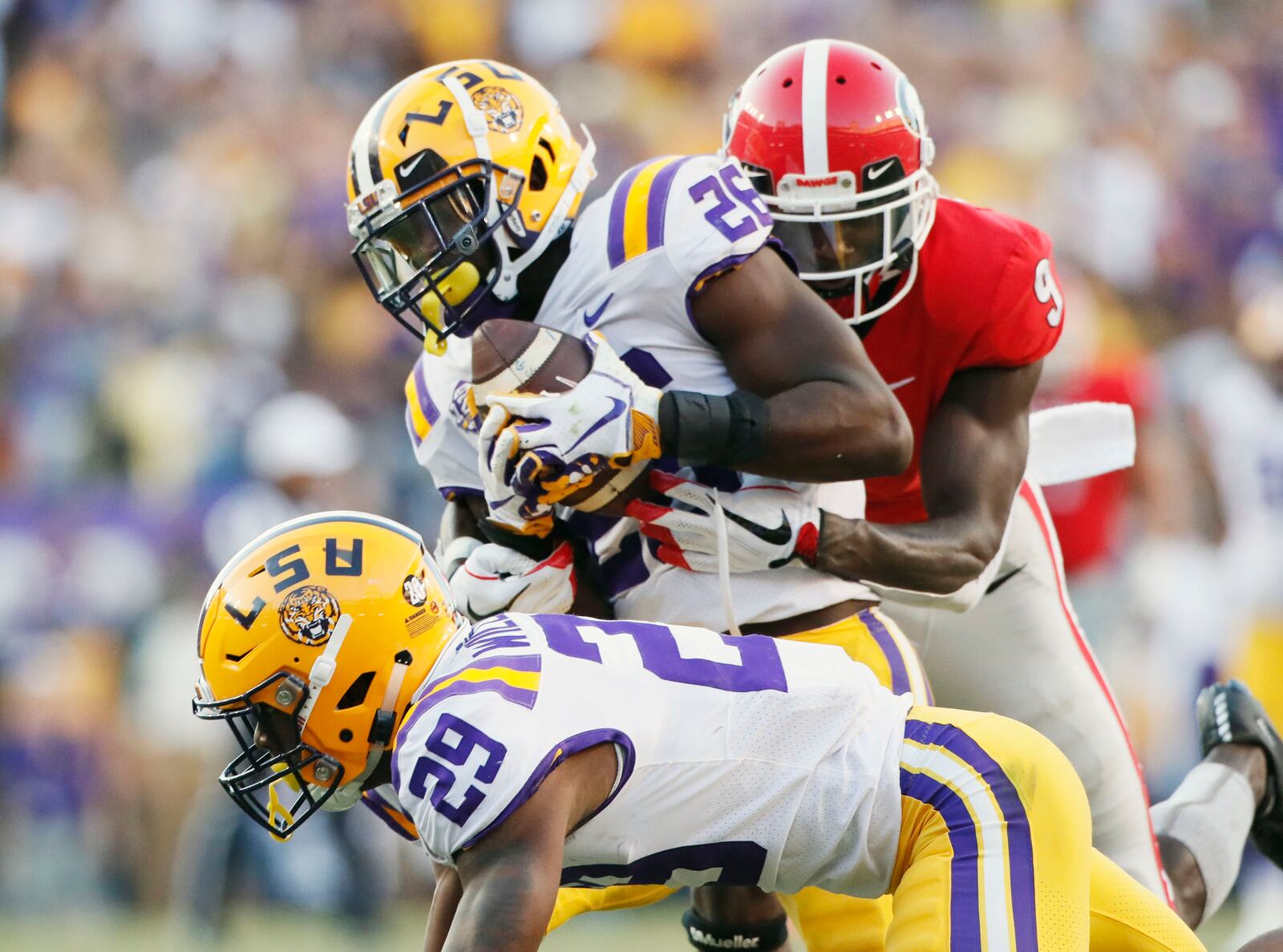 10/13/18 - Baton Rouge -  LSU Tigers safety John Battle (26), with assistance from  LSU Tigers cornerback Greedy Williams (29),  intercepts a  Georgia Bulldogs quarterback Jake Fromm pass intended for Georgia Bulldogs wide receiver Jeremiah Holloman (9) late in the 4th quarter to seal the Tigers victory.  The Tigers won 36-16.   The University of Georgia Bulldogs played the Louisiana State University Tigers in a NCAA college football game Saturday, October 13, 2018, at Tiger Stadium in Baton Rouge, LA.    BOB ANDRES / BANDRES@AJC.COM