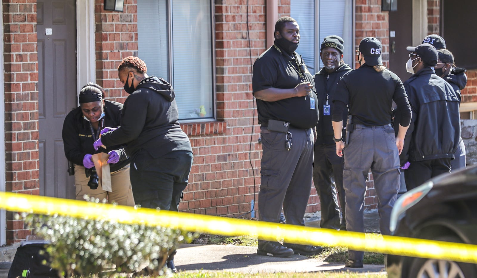 Police inspect the scene of a homicide at Appletree Townhomes in February 2022. The complex is owned by a company tied to New York-based Tusk Equity Partners, which in recent years has held seven of the metro area’s most dangerous properties through affiliated companies. (John Spink / John.Spink@ajc.com)