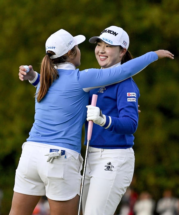 Rio Takeda of Japan, right, gets a hug from Marina Alex of the U.S. as she wins the LPGA's Toto Japan Classic in a playoff at the Seta Golf Course in Otsu, western Japan, Sunday, Nov. 3, 2024. (Keiji Uesho/Kyodo News via AP)