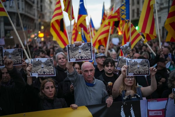 Demonstrators gather for a protest organized by social and civic groups, denouncing the handling of recent flooding under the slogan "Mazón, Resign," aimed at the president of the regional government Carlos Mazon, in Valencia, Spain, Saturday, Nov. 9, 2024. (AP Photo/Emilio Morenatti)