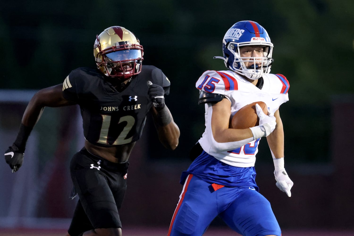 Sept. 24, 2021 - Johns Creek, Ga: Riverwood tight end Levi Linowes (15) runs after a catch pursued by Johns Creek defensive back LeBron Morgan (12) during the first half at Johns Creek high school Friday, September 24, 2021 in Johns Creek, Ga.. JASON GETZ FOR THE ATLANTA JOURNAL-CONSTITUTION